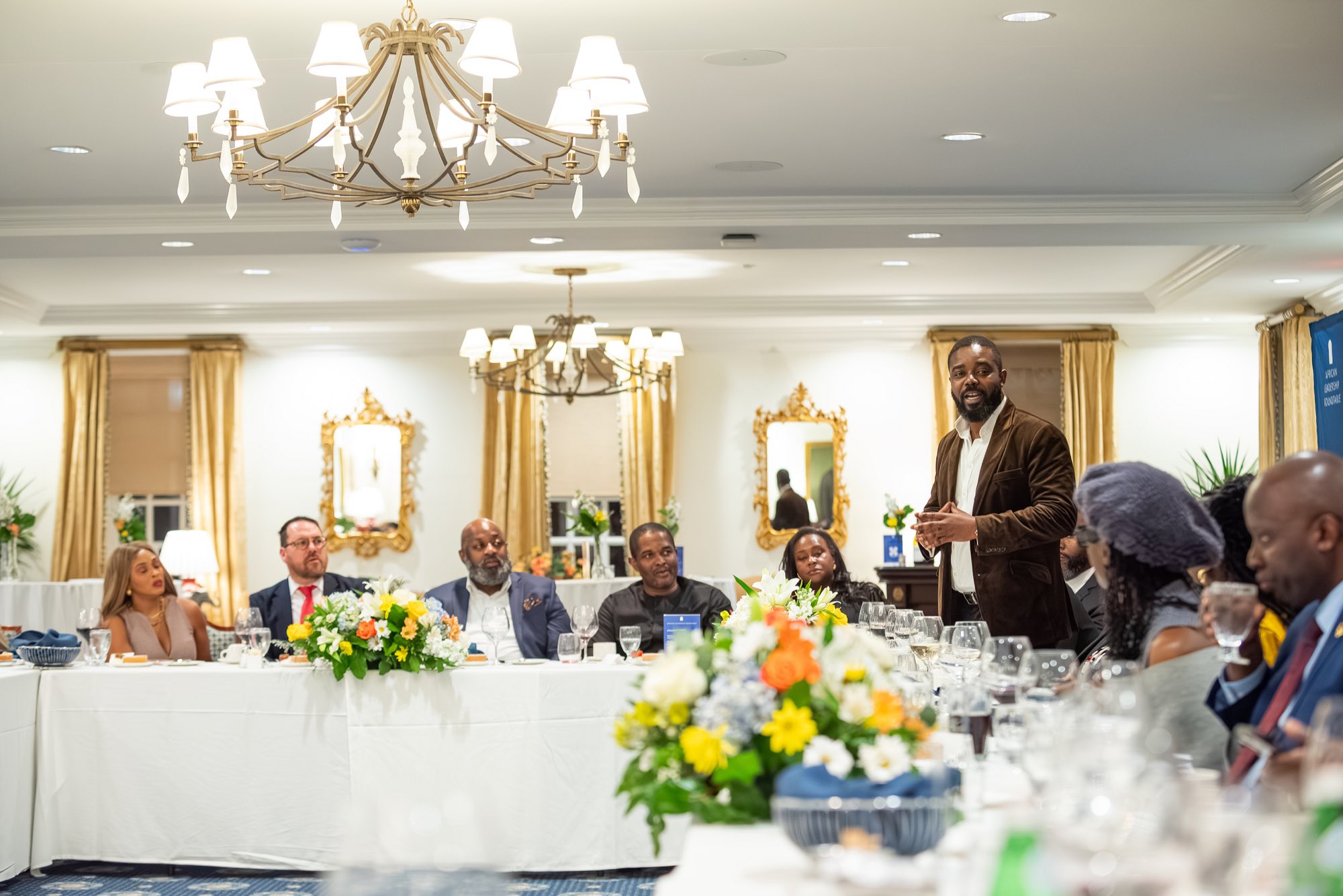 A delegate addressing the room from the head table at a previous African Leadership Roundtable