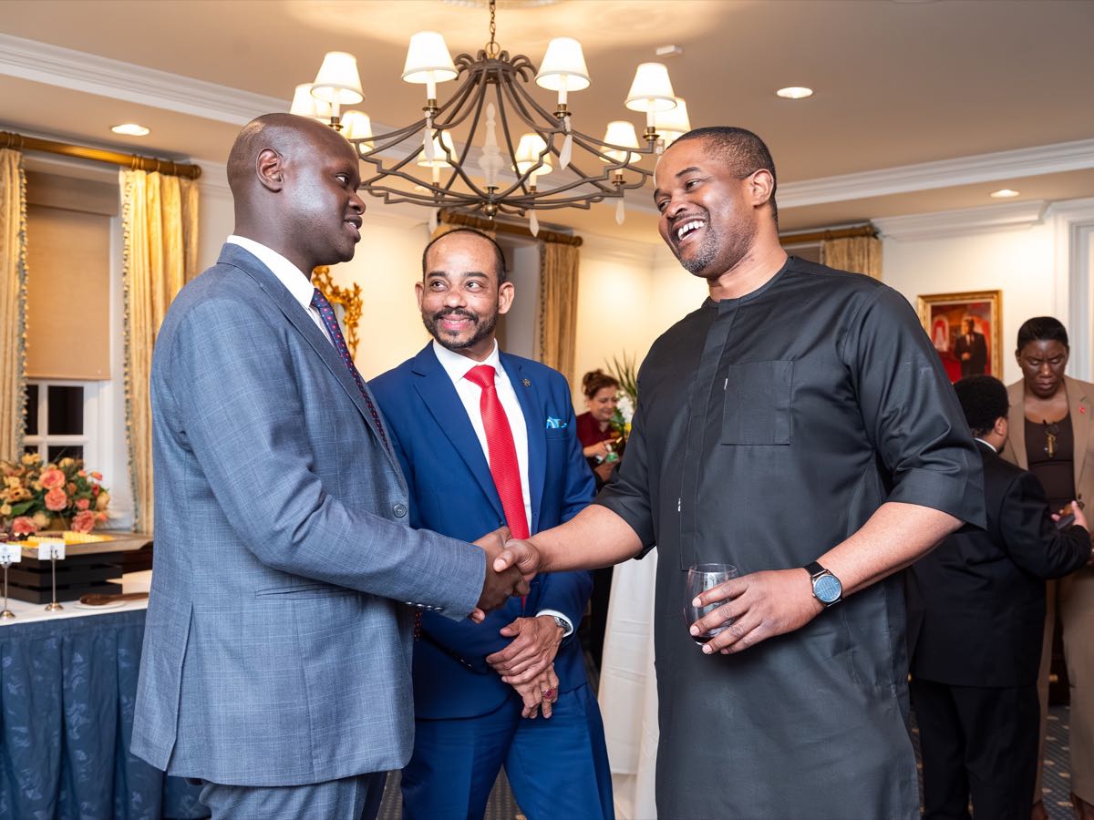 Three delegates shaking hands during the reception